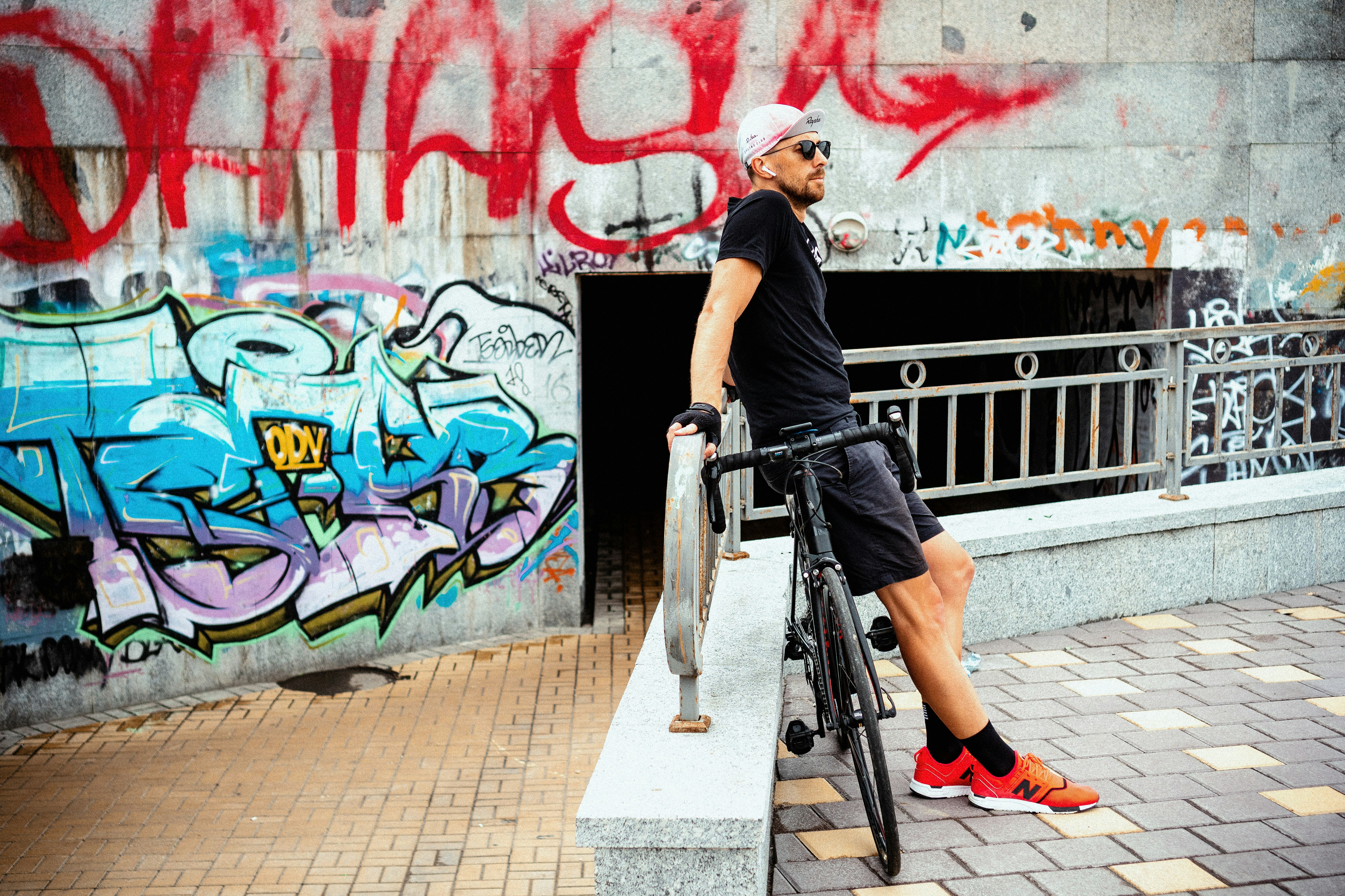 man sitting on black road bike